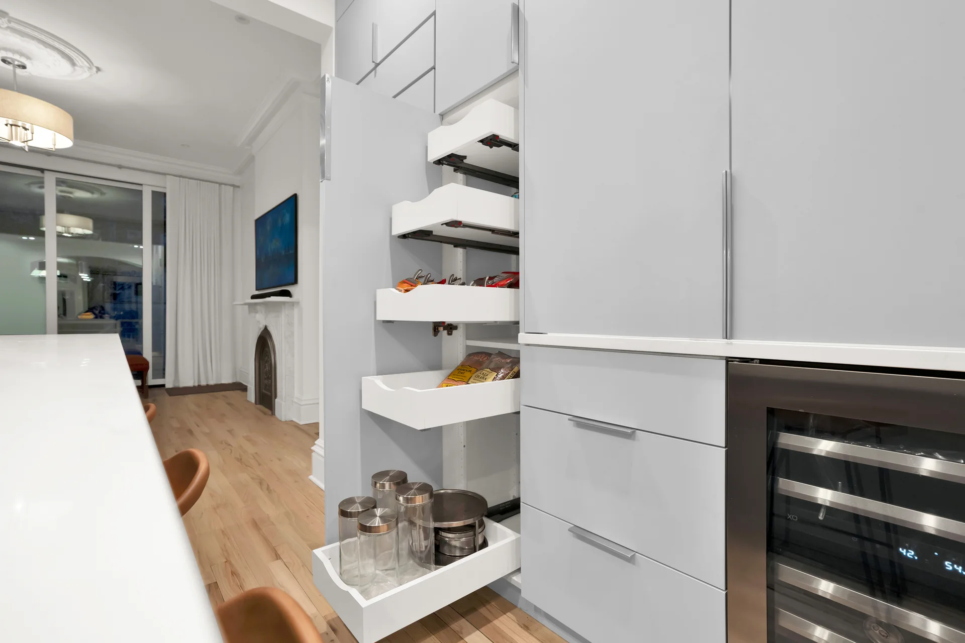Open kitchen pantry with several pullout shelves